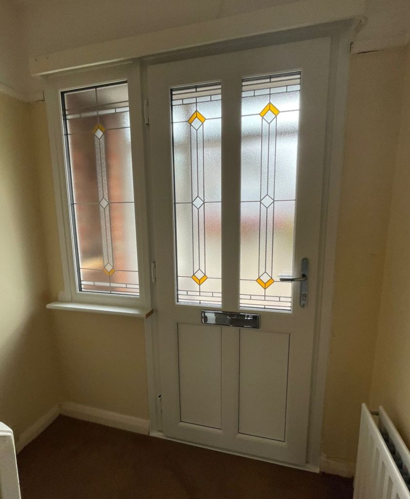 Interior view of grey and white John Fredericks Plastics Ultimate PVC-u entrance door with matching sidelight.