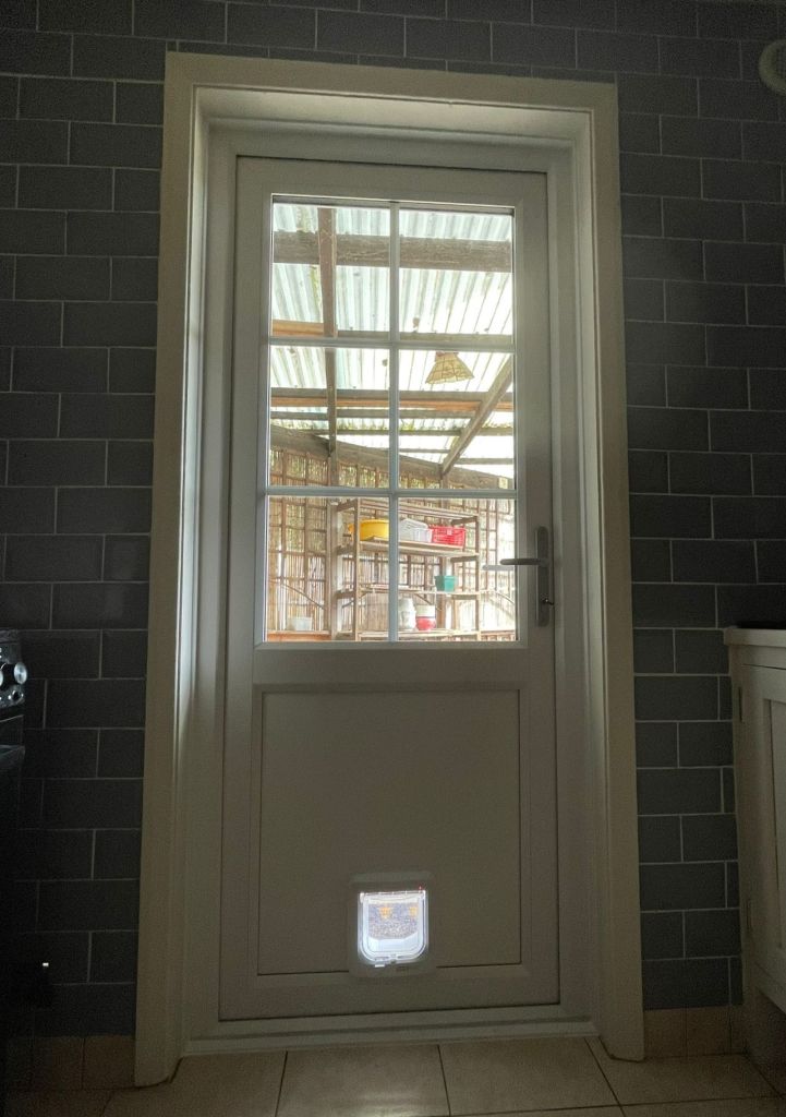 Inside view of a John Fredericks Plastics PVCu door with Georgian bar and cat flap installed in a Croydon home.