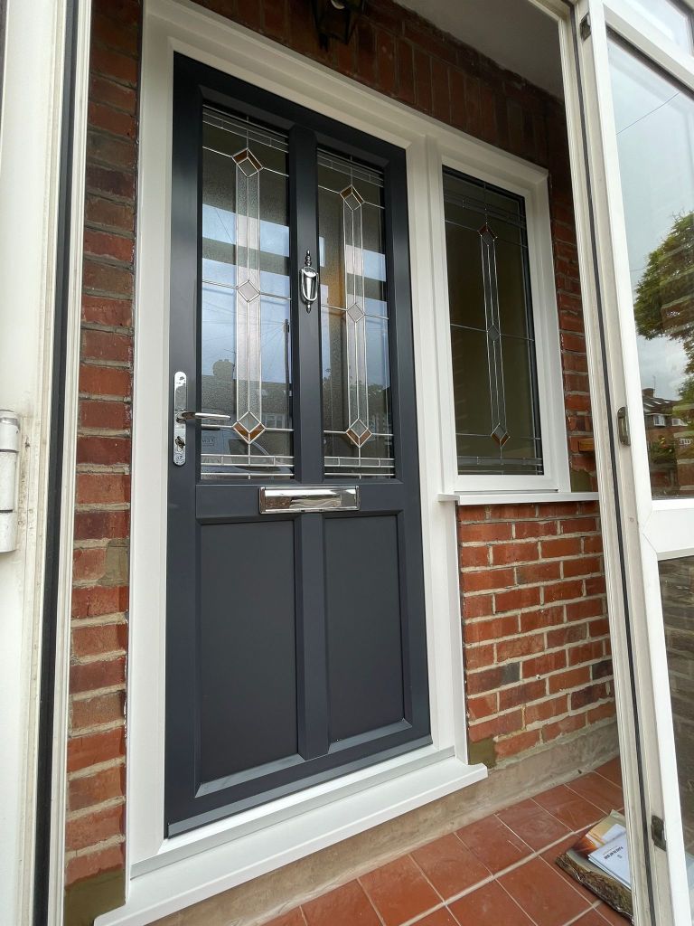 Grey and white John Fredericks Plastics Ultimate PVC-u entrance door with decorative glass, installed in London.