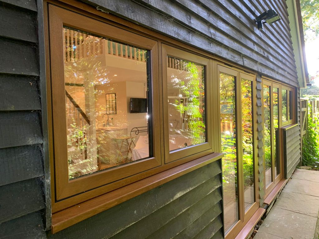 Cherrywood Flush Sash Windows installed on a dark timber-clad exterior in Shoreham.